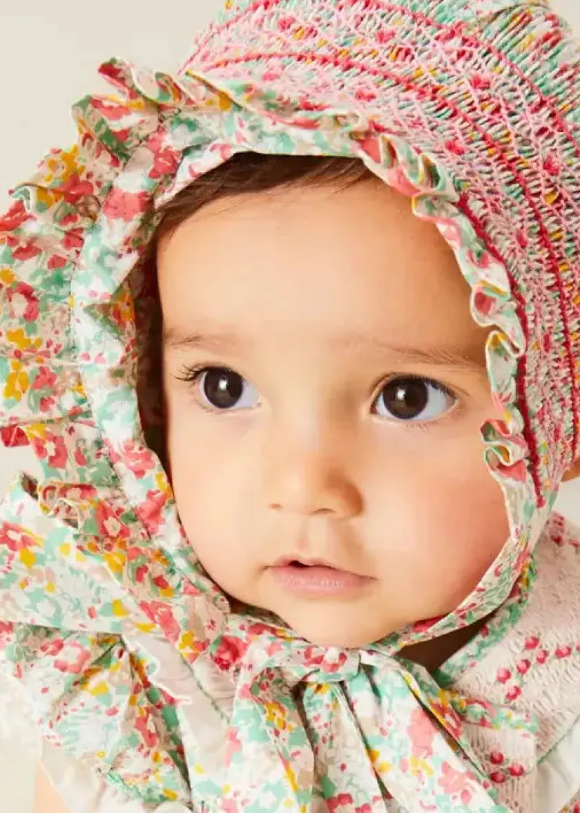 Lookbooks | Pepa London Clementine Floral Hand Smocked Double Breasted Short Sleeve Romper in Coral (6mths-3yrs) | Clementine Floral Hand Smocked Bonnet in Coral (S-M) | Openwork Cotton Cardigan in Cream (6mths-10yrs) | Leather Mary Jane Pram Shoes in Ivory (17-20EU) | Openwork short socks White (0mths-8yrs)