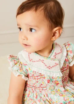 Lookbooks | Pepa London Clementine Floral Hand Smocked Double Breasted Short Sleeve Romper in Coral (6mths-3yrs) | Clementine Floral Hand Smocked Bonnet in Coral (S-M) | Openwork Cotton Cardigan in Cream (6mths-10yrs) | Leather Mary Jane Pram Shoes in Ivory (17-20EU) | Openwork short socks White (0mths-8yrs)