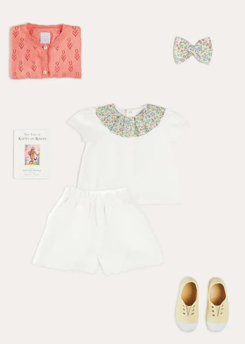 Lookbooks | Pepa London Cordelia Floral Collar Top in Pink Made with Liberty Fabric (2-10yrs) | Scallop Trim Embroidered Shorts in White (2-10yrs) | Floral Openwork Cotton Cardigan in Pink (2-10yrs) | Canvas Plimsolls in Cream (20-35EU) | Cordelia Floral Medium Bow Clip in Pink Made with Liberty Fabric | The Tale Of Kitty In Boots Book in White
