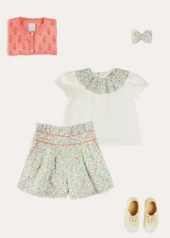 Lookbooks | Pepa London Cordelia Floral Collar Top in Pink Made with Liberty Fabric (2-10yrs) | Cordelia Floral Shorts in Pink Made with Liberty Fabric (4-10yrs) | Floral Openwork Cotton Cardigan in Pink (2-10yrs) | Canvas Plimsolls in Cream (20-35EU) | Cordelia Floral Medium Bow Clip in Pink Made with Liberty Fabric