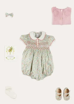 Lookbooks | Pepa London Cordelia Floral Hand-Smocked Short Sleeve Romper in Pink Made with Liberty Fabric (3m-2yrs) | Openwork Cotton Knitted Bonnet in Pink (S-L) | Openwork Cotton Cardigan in Pink (6mths-10yrs) | Cordelia Liberty Floral Mary Jane Pram Shoes in Pink (17-20EU) | Flower Fairies of the Spring Book in White | Cordelia Floral Small Bow Clip in Pink Made with Liberty Fabric | Openwork short socks White (0mths-8yrs)