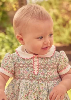 Lookbooks | Pepa London Cordelia Floral Hand-Smocked Short Sleeve Romper in Pink Made with Liberty Fabric (3m-2yrs) | Openwork Cotton Knitted Bonnet in Pink (S-L) | Openwork Cotton Cardigan in Pink (6mths-10yrs) | Cordelia Liberty Floral Mary Jane Pram Shoes in Pink (17-20EU) | Flower Fairies of the Spring Book in White | Cordelia Floral Small Bow Clip in Pink Made with Liberty Fabric | Openwork short socks White (0mths-8yrs)