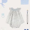 Lookbooks | Pepa London Ellis Sleeveless Dress with Bloomer and Bows in Blue Made with Liberty Fabric (1-12m) | Openwork Detail Baby Cardigan in Blue (1-12mths) | Lace Detail Knitted Bonnet in Blue (1-6mths) | Lace Detail Knitted Booties in Blue | Ellis Dummy Clip in Blue Made with Liberty Fabric | BIBS Dummy in Blue