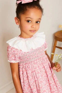 Lookbooks | Pepa London Emilia Floral Hand Smocked Ruffle Collar Short Sleeve Dress in Pink (12mths-10yrs) | Openwork Cotton Cardigan in Cream (6mths-10yrs) | Girls Ivory Leather Mary Jane Shoes (20-34EU) | Emilia Floral Long Bow Hair Clip in Pink | Openwork short socks White (0mths-8yrs)