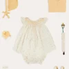 Lookbooks | Pepa London Esme Floral Hand Smocked Sleeveless Dress With Bloomers in White (1-12mths) | Openwork Detail Cotton Baby Cardigan in Tangerine (1-12mths) | Lace Detail Knitted Bonnet in Tangerine (1-12mths) | Celebration Ribbon Detail Mary Jane Pram Shoes in Beige (17-20EU) | Esme Floral Dummy Clip in White | Openwork short socks White (0mths-8yrs) | Chick Toy in Yellow