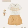 Lookbooks | Pepa London Hand Smocked Peter Pan Collar Short Sleeve Two Piece Set in Beige (18mths-6yrs) | Plain Cardigan in Cream (6mths-10yrs) | T-Bar Leather Baby Shoes in Ivory (20-24EU) | Cotton Short Socks Cream (0mths-10yrs)