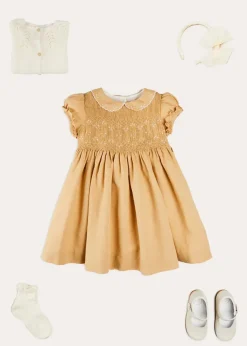 Lookbooks | Pepa London Hand Smocked Peter Pan Collar Short Sleeve Dress in Beige (12mths-10yrs) | Openwork Cotton Cardigan in Cream (6mths-10yrs) | Mary Jane Leather Baby Shoes in Ivory (20-24EU) | Traditional Big Bow Tulle Hairband in Ivory | Celebration Short Socks with Ruffle- Cream (0mths-10yrs)