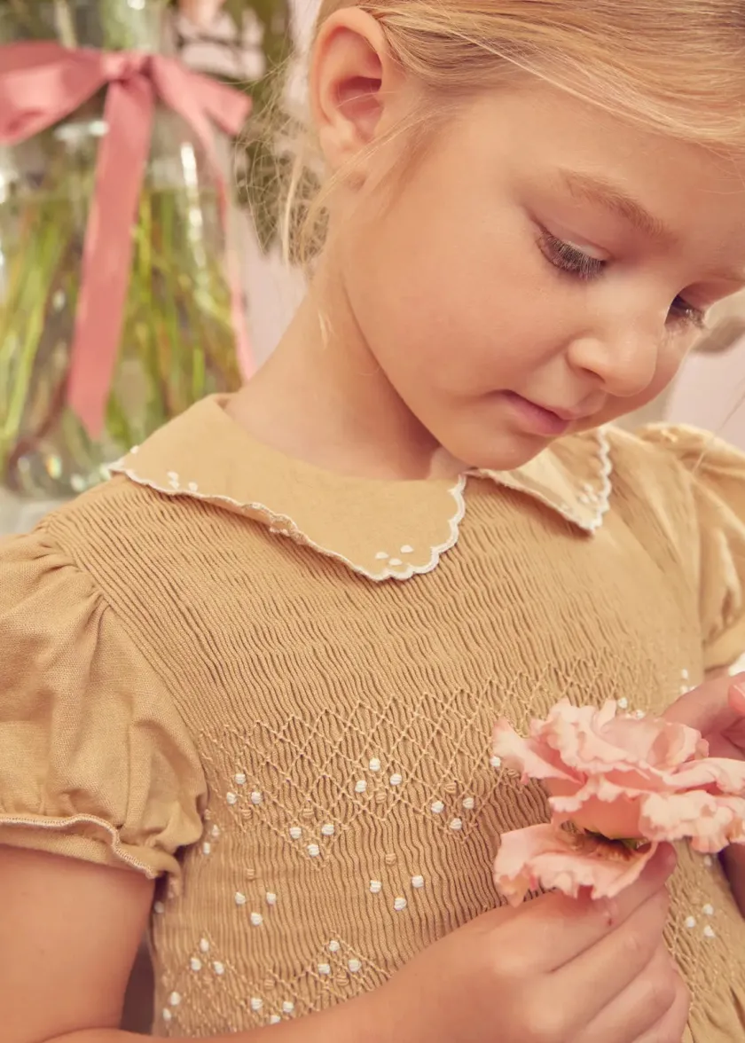 Lookbooks | Pepa London Hand Smocked Peter Pan Collar Short Sleeve Dress in Beige (12mths-10yrs) | Openwork Cotton Cardigan in Cream (6mths-10yrs) | Mary Jane Leather Baby Shoes in Ivory (20-24EU) | Traditional Big Bow Tulle Hairband in Ivory | Celebration Short Socks with Ruffle- Cream (0mths-10yrs)