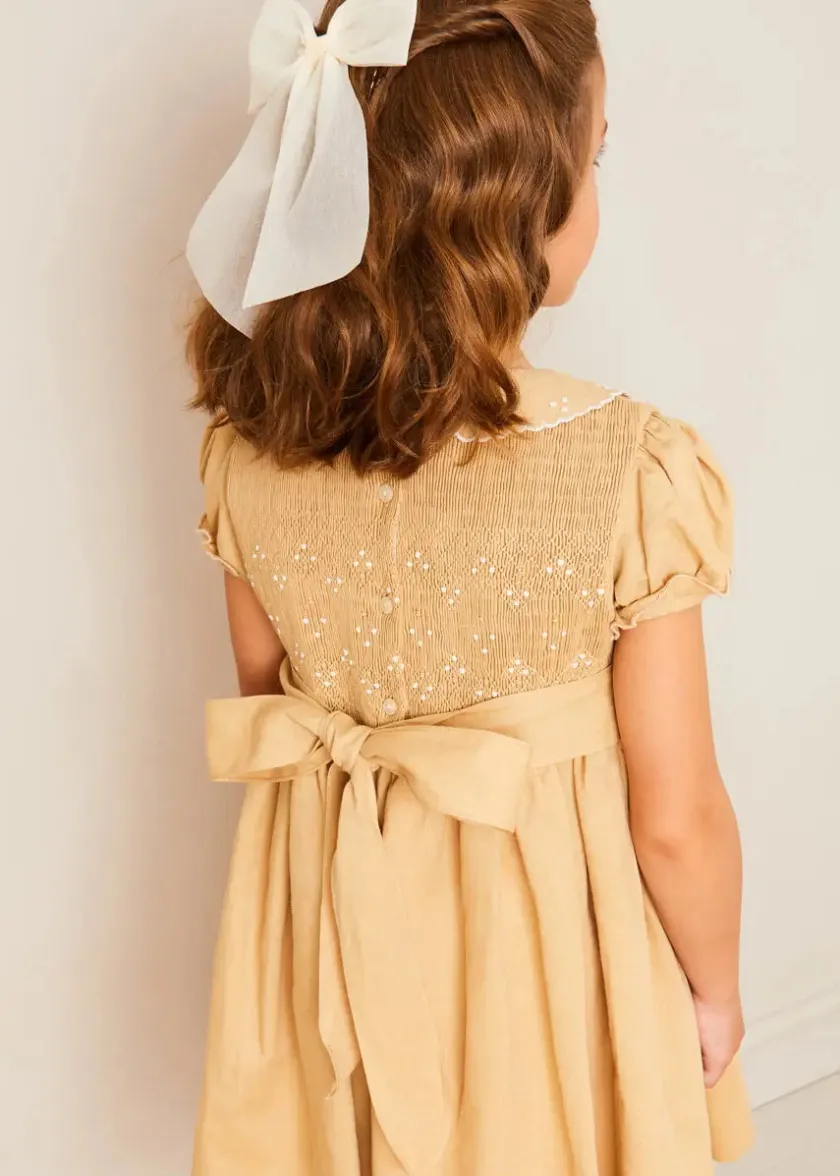 Lookbooks | Pepa London Hand Smocked Peter Pan Collar Short Sleeve Dress in Beige (12mths-10yrs) | Openwork Cotton Cardigan in Cream (6mths-10yrs) | Girls Ivory Leather Mary Jane Shoes (20-34EU) | Traditional Big Bow Tulle Hairband in Ivory | Celebration Short Socks with Ruffle- Cream (0mths-10yrs) | Tulle Long Bow Clip In Cream