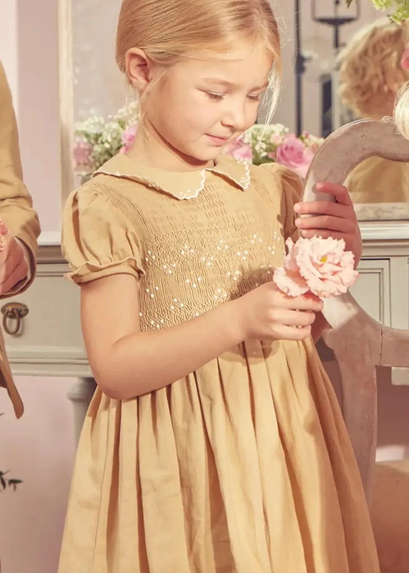 Lookbooks | Pepa London Hand Smocked Peter Pan Collar Short Sleeve Dress in Beige (12mths-10yrs) | Openwork Cotton Cardigan in Cream (6mths-10yrs) | Mary Jane Leather Baby Shoes in Ivory (20-24EU) | Traditional Big Bow Tulle Hairband in Ivory | Celebration Short Socks with Ruffle- Cream (0mths-10yrs)
