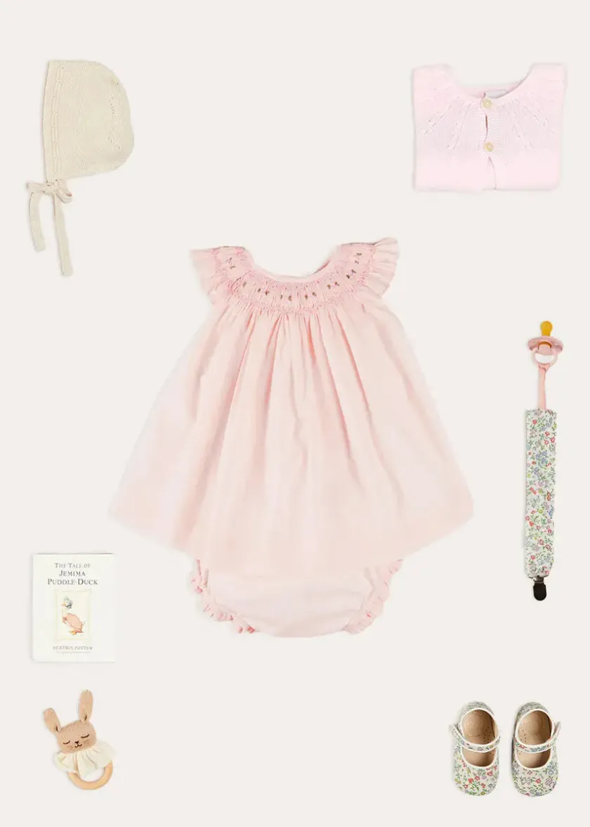 Lookbooks | Pepa London Hand Smocked Sleeveless Dress With Bloomers in Pink (1-12mths) | Openwork Detail Baby Cardigan in Pink (1-12mths) | Openwork Knitted Bonnet in Beige(S-L) | Cordelia Liberty Floral Mary Jane Pram Shoes in Pink (17-20EU) | Cordelia Liberty Floral Dummy Clip in Pink | Knitted Bunny Teether in Beige | BIBS Dummy in Pink
