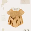 Lookbooks | Pepa London Peter Pan Collar Hand Smocked Short Sleeve Romper in Camel (6mths-2yrs) | Plain Cardigan in Cream (6mths-10yrs) | Openwork Knitted Bonnet in Beige(S-L) | T-Bar Leather Pram Shoes in Ivory (17-20EU) | Cotton Short Socks Cream (0mths-10yrs)