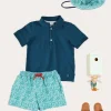 Lookbooks | Pepa London Plain Short Sleeve Polo Shirt in Navy (2-10yrs) | Adelaide Floral Tie Detail Swim Shorts in Green (2-10yrs) | Suede Buckle Detail Sandals in Beige (28-35EU) | Adelaide Floral Beach Hat in Green (S-M) | Big Brother Beach Mouse Toy