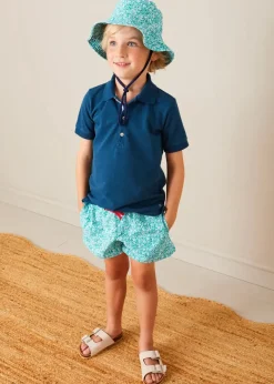 Lookbooks | Pepa London Plain Short Sleeve Polo Shirt in Navy (2-10yrs) | Adelaide Floral Tie Detail Swim Shorts in Green (2-10yrs) | Suede Buckle Detail Sandals in Beige (28-35EU) | Adelaide Floral Beach Hat in Green (S-M) | Big Brother Beach Mouse Toy