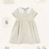 Lookbooks | Pepa London Waterford Striped Mariner Collar Double Breasted Short Sleeve Dress in Beige (12mths-10yrs) | Openwork Cotton Cardigan in Cream (6mths-10yrs) | Girl's Beige Leather Celebration Shoes (20-34EU) | Tulle Long Bow Clip In Cream | Cotton Short Socks Cream (0mths-10yrs)